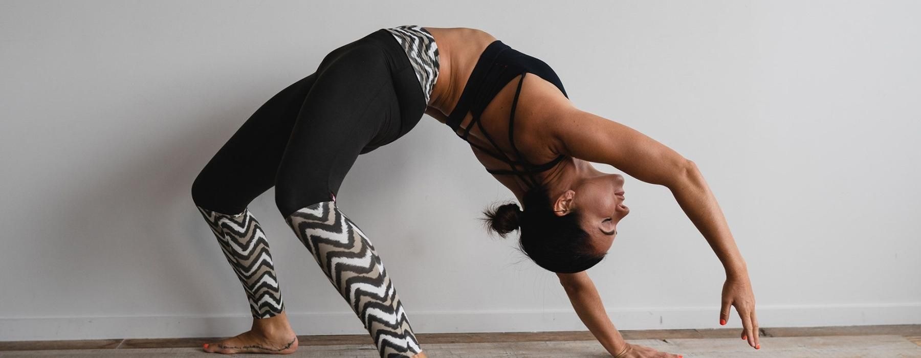 woman bending over backwards in an exercise studio
